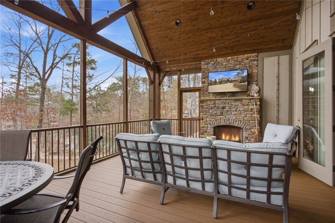 412 Walking Fern Way Seneca, SC 29672 - Photo 13 of 45 Relax in this screened porch, complete with a gas log cultured stone fireplace for ultimate comfort.