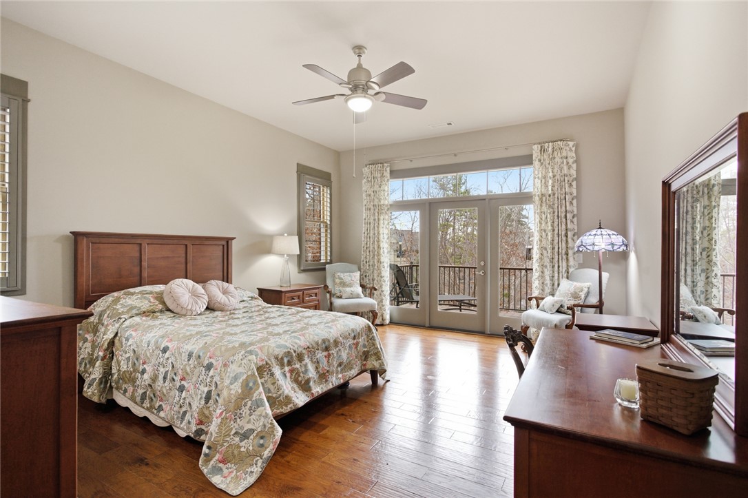 412 Walking Fern Way Seneca, SC 29672 - Photo 16 of 45 This primary bedroom offers warm hardwood floors, and a private balcony.