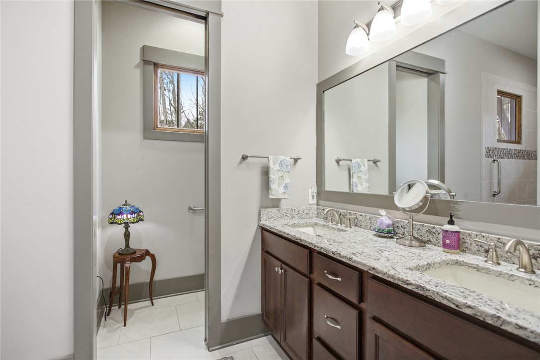 412 Walking Fern Way Seneca, SC 29672 - Photo 18 of 45 This bathroom offers dual vanities with granite counters and tile flooring.