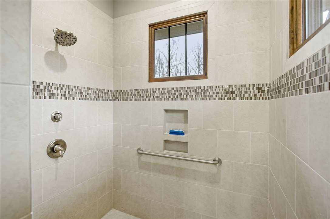 412 Walking Fern Way Seneca, SC 29672 - Photo 19 of 45 Step into this beautifully tiled shower featuring a window for natural light and contemporary fixtures.