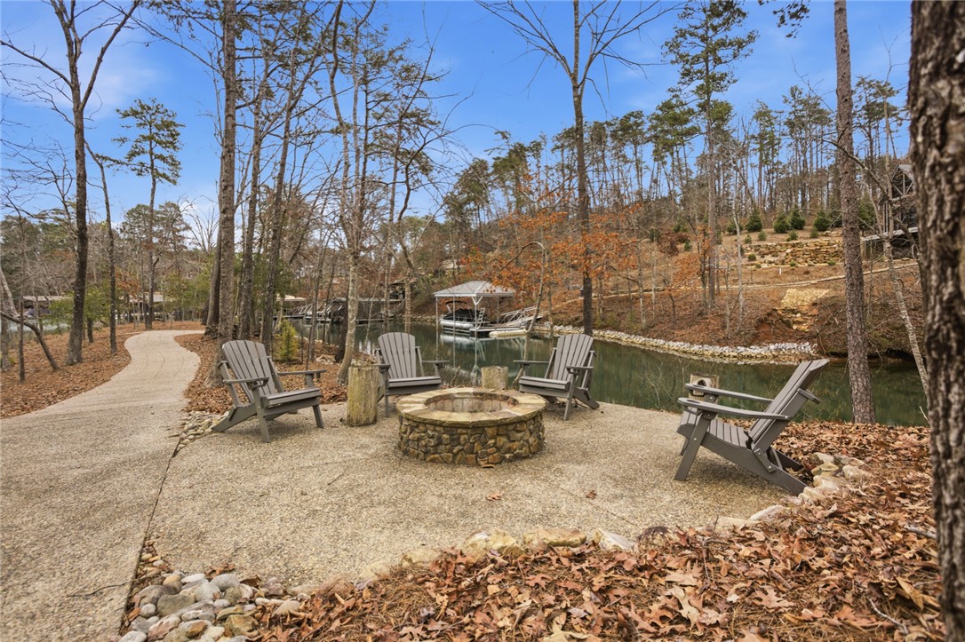 412 Walking Fern Way Seneca, SC 29672 - Photo 35 of 45 This serene waterfront retreat features a fire pit, perfect for outdoor gatherings by the water.
