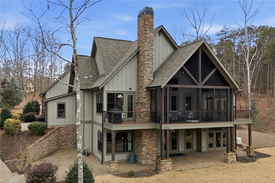 412 Walking Fern Way Seneca, SC 29672 - Photo 44 of 45 This captivating residence features a multi-level design with a prominent stone chimney and a screened-in porch.