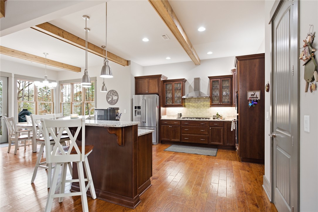 412 Walking Fern Way Seneca, SC 29672 - Photo 6 of 45 This luminous kitchen boasts rich wood cabinetry, stainless steel appliances, and a welcoming breakfast bar.