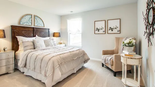 a bedroom with bed and wooden floor