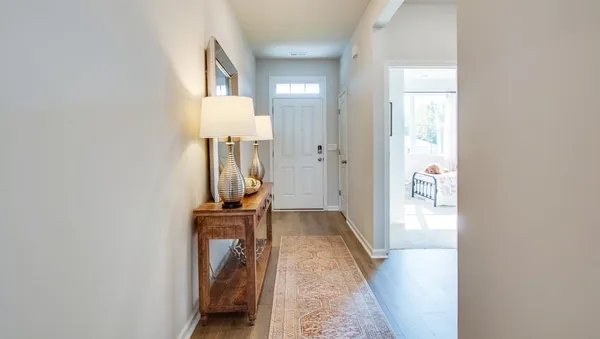view of a hallway with wooden floor and staircase