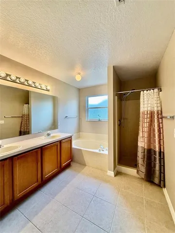 a large bathroom with a tub and shower