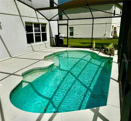 a view of a swimming pool with an outdoor seating