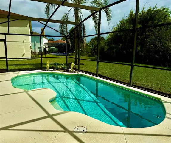 a view of swimming pool with a backyard