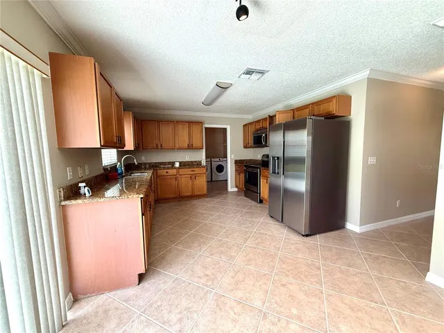 a kitchen with refrigerator and cabinets