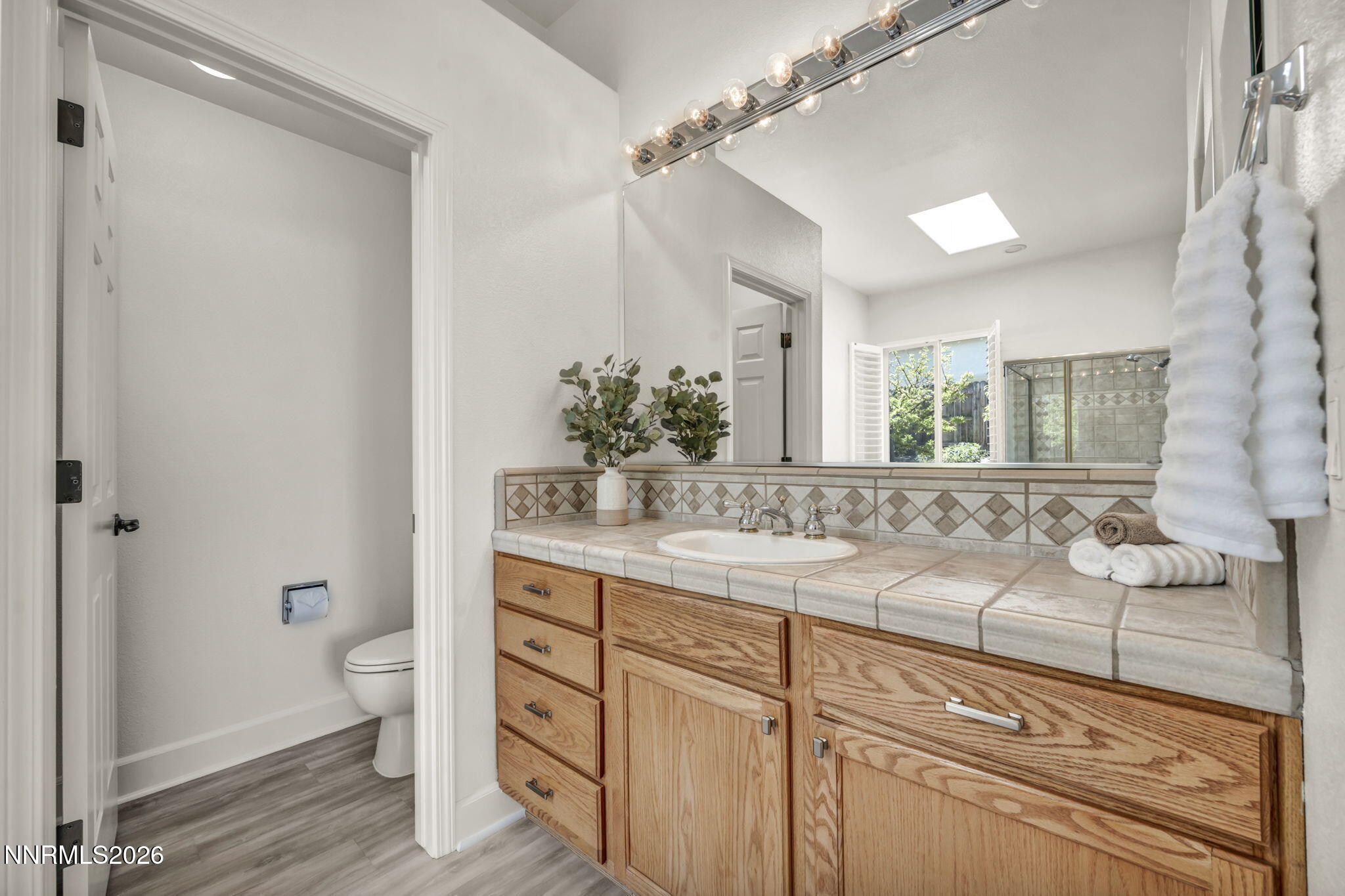 574 Echo Ridge Court Reno, NV 89511 - Photo 35 of 58 a bathroom with a sink and a mirror