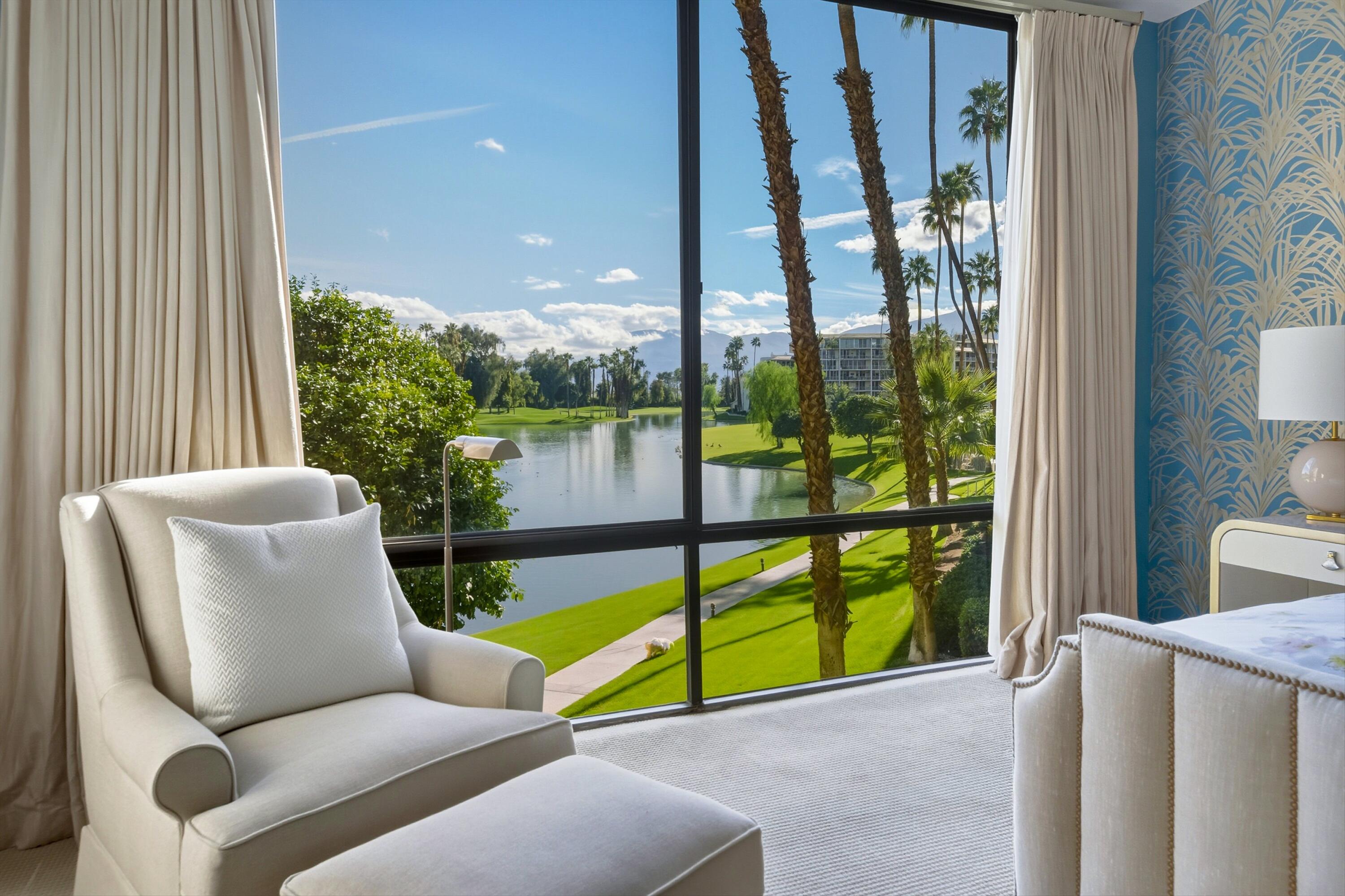 910 Island Drive, Unit 207 Rancho Mirage, CA 92270 - Photo 1 of 27 a blue bench sitting in front of a building