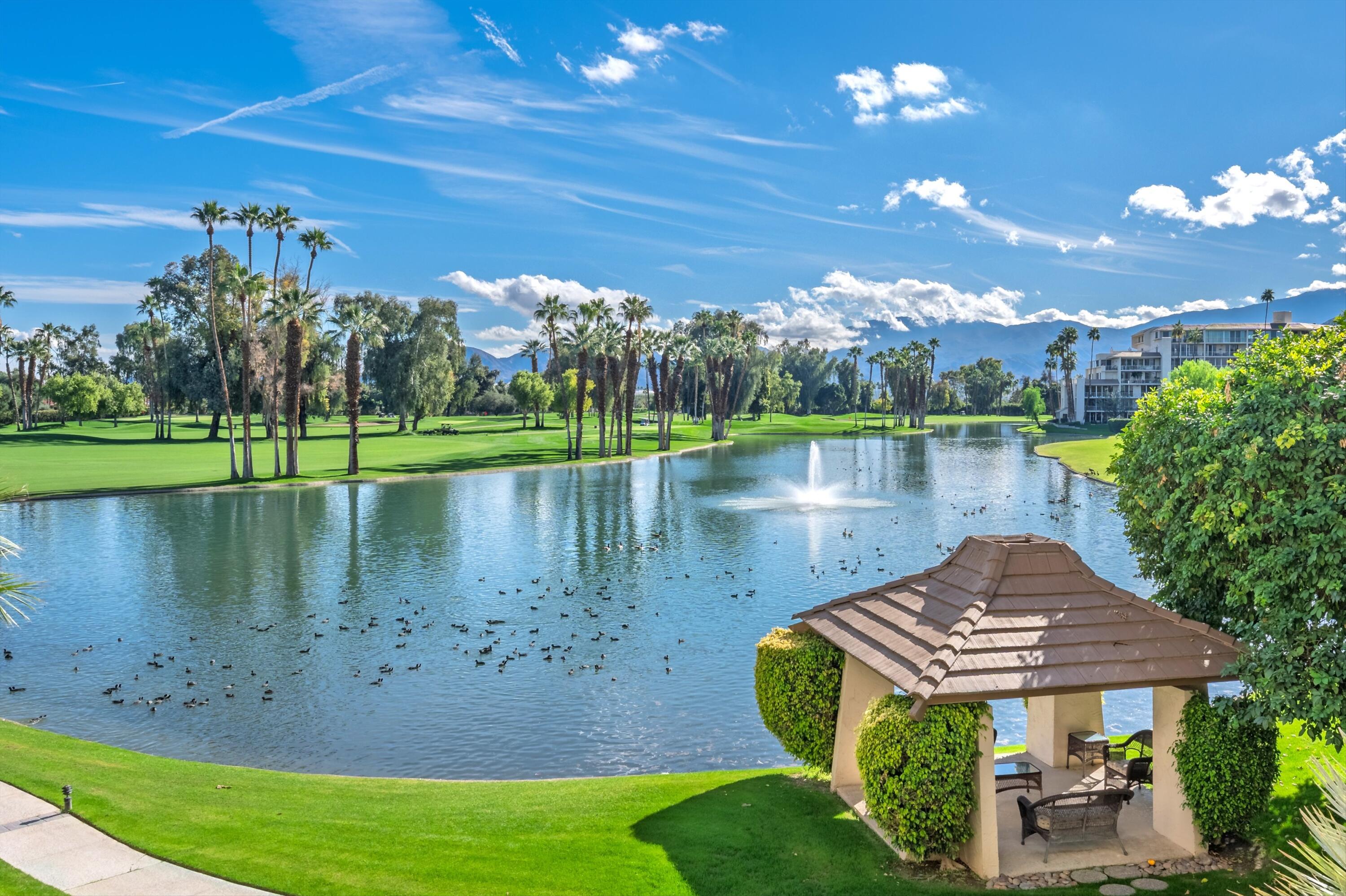 910 Island Drive, Unit 207 Rancho Mirage, CA 92270 - Photo 11 of 27 a view of a lake with a big yard