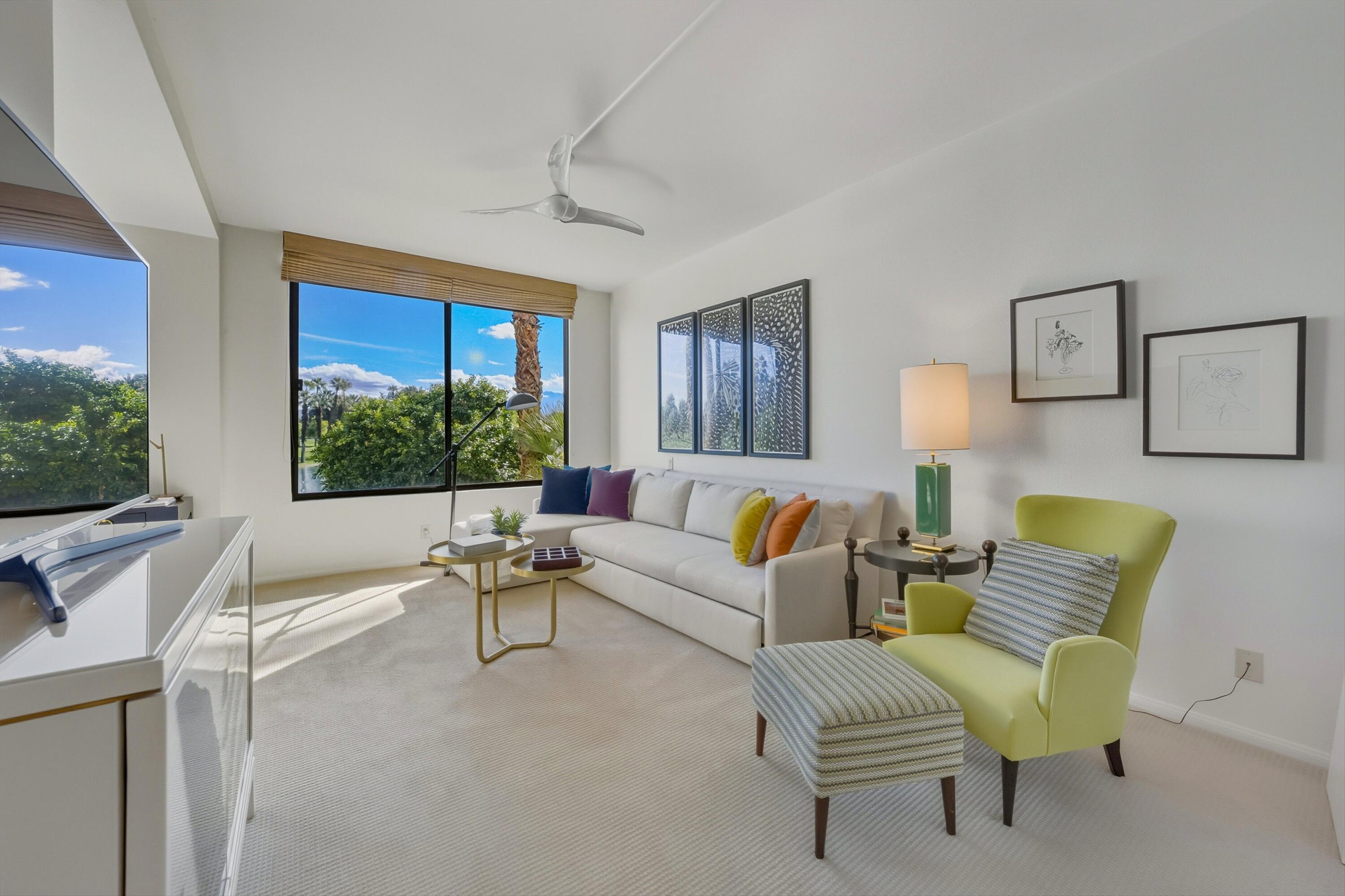 910 Island Drive, Unit 207 Rancho Mirage, CA 92270 - Photo 16 of 27 a living room with furniture and a large window