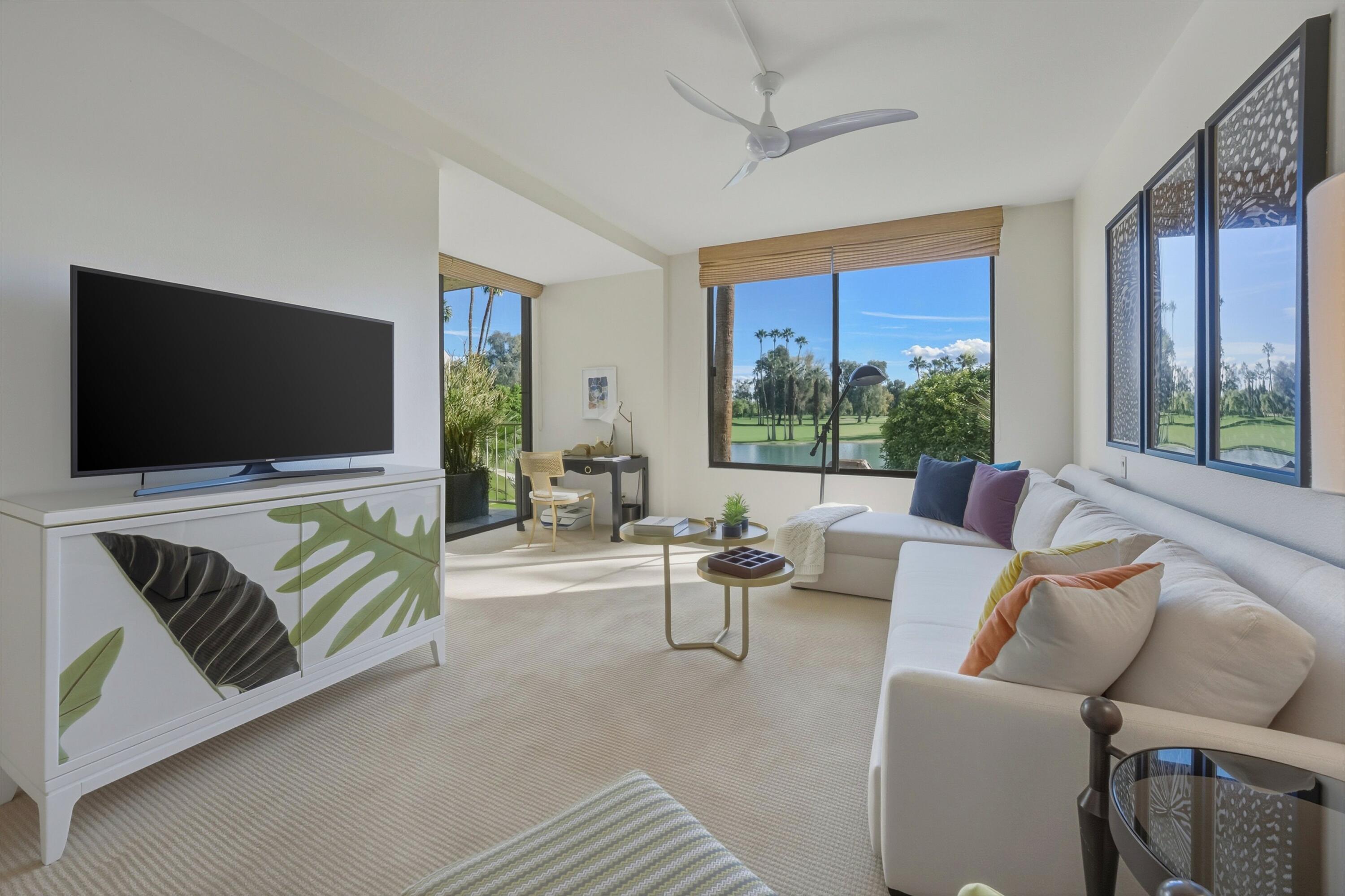 910 Island Drive, Unit 207 Rancho Mirage, CA 92270 - Photo 17 of 27 a living room with furniture and a flat screen tv