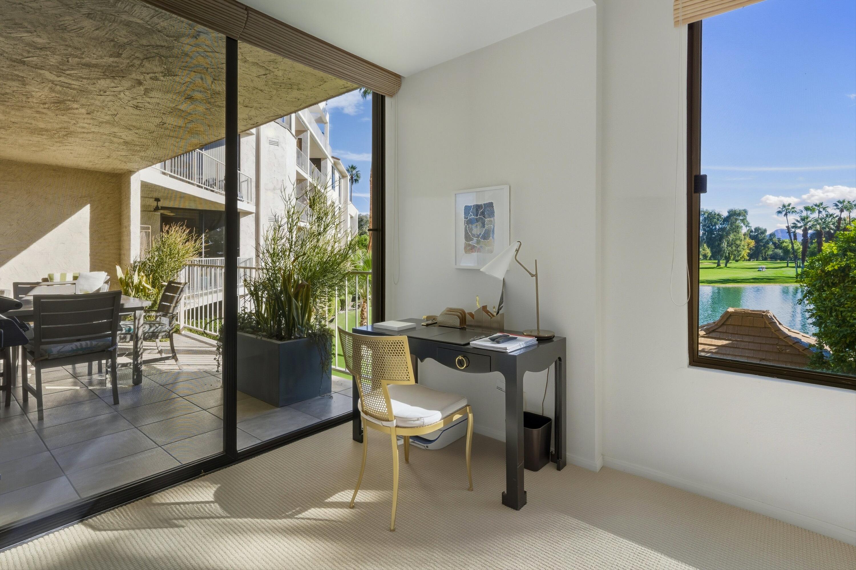 910 Island Drive, Unit 207 Rancho Mirage, CA 92270 - Photo 18 of 27 a living room with furniture and a potted plant