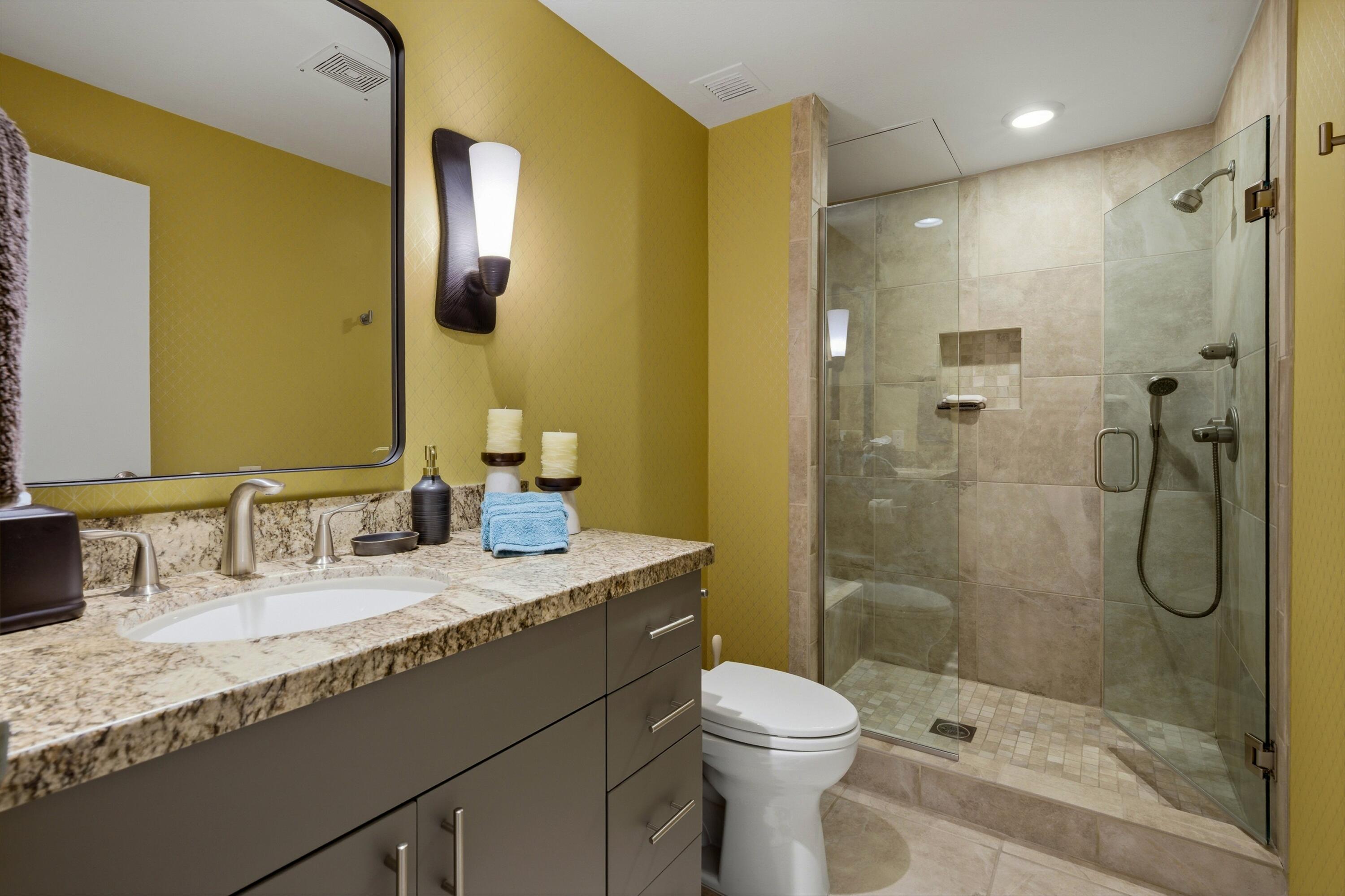 910 Island Drive, Unit 207 Rancho Mirage, CA 92270 - Photo 19 of 27 a bathroom with a granite countertop sink a toilet and shower