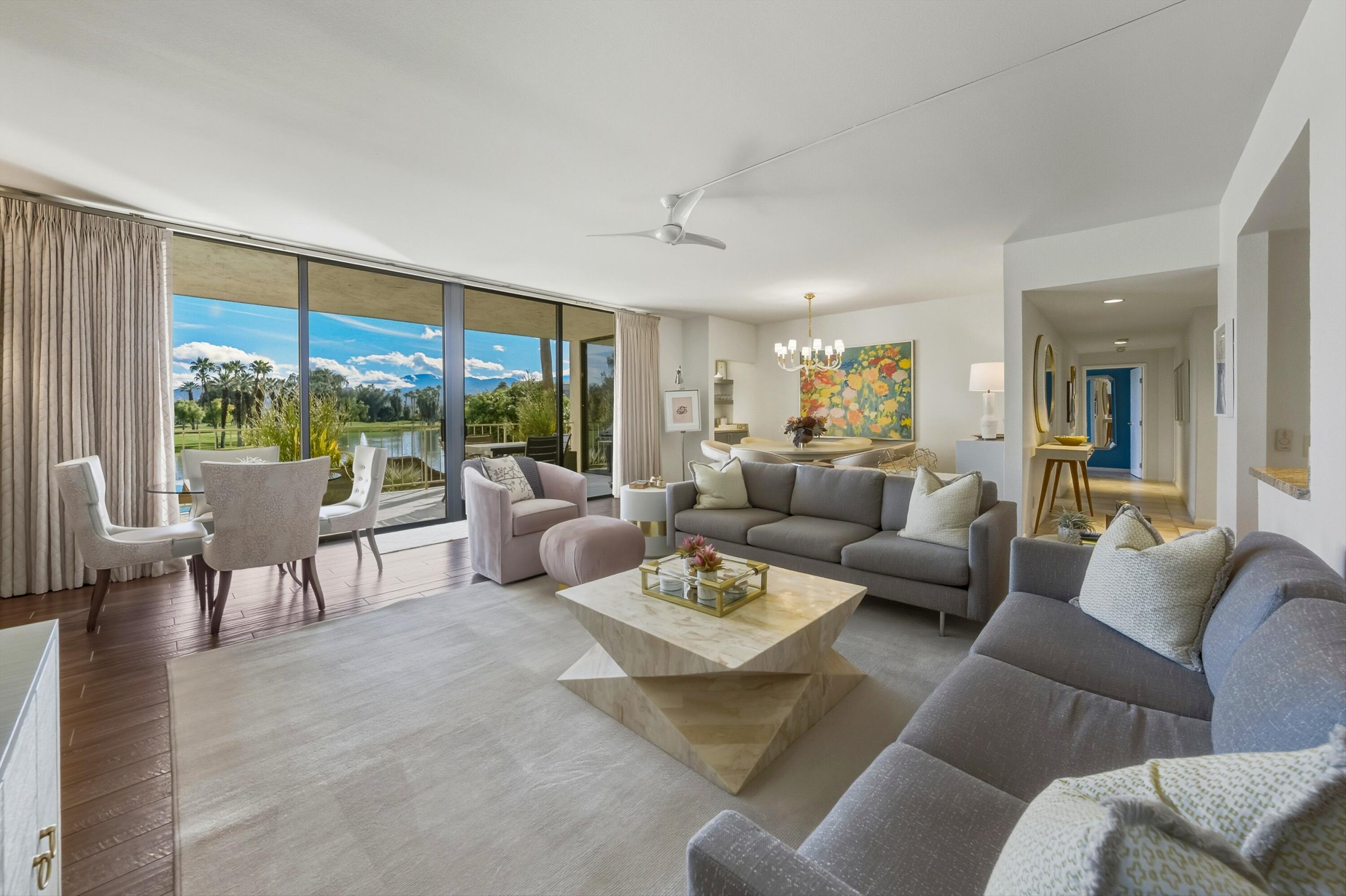 910 Island Drive, Unit 207 Rancho Mirage, CA 92270 - Photo 3 of 27 a living room with furniture and a large window
