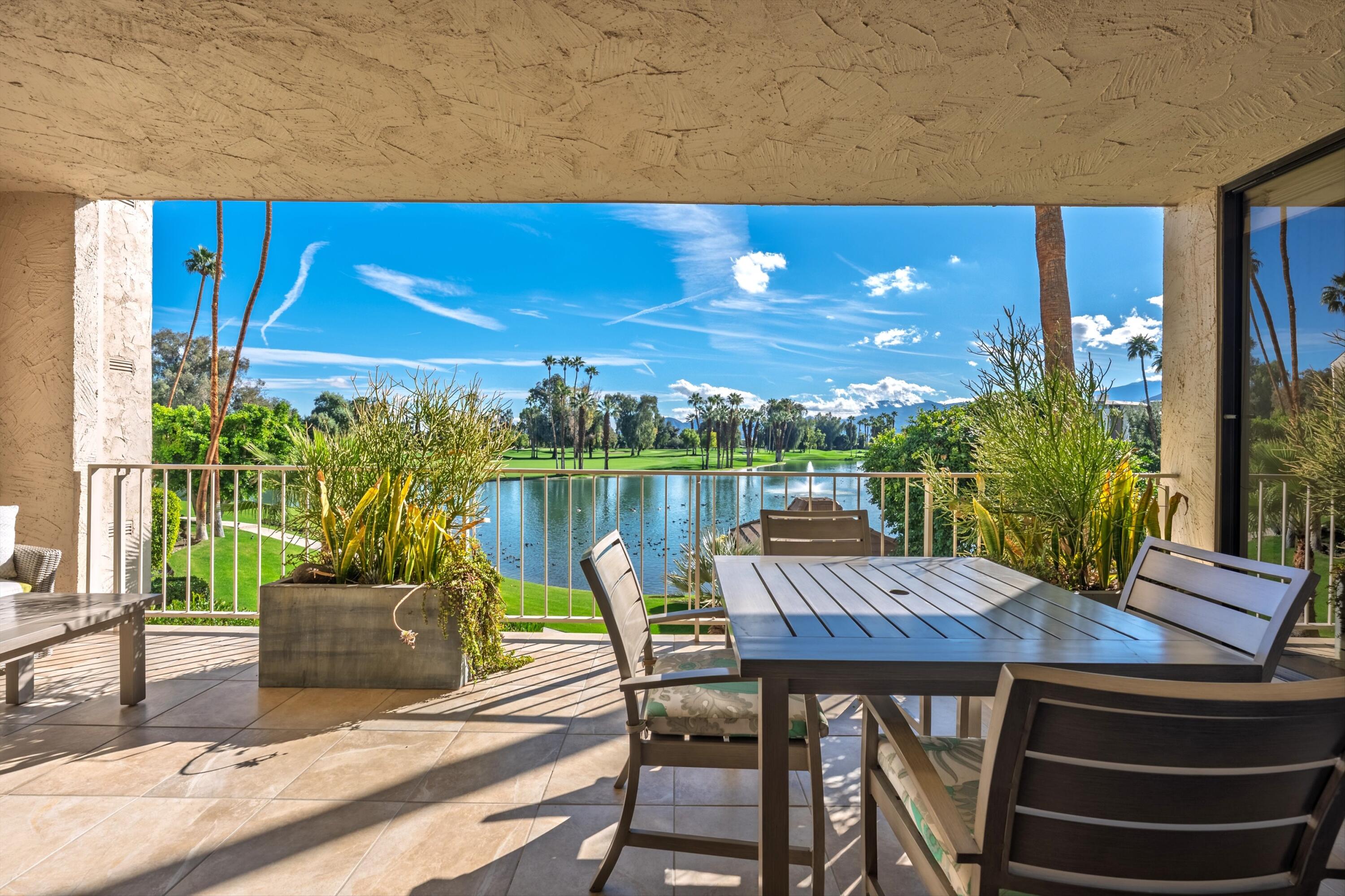 910 Island Drive, Unit 207 Rancho Mirage, CA 92270 - Photo 7 of 27 a view of a chairs and table on the terrace