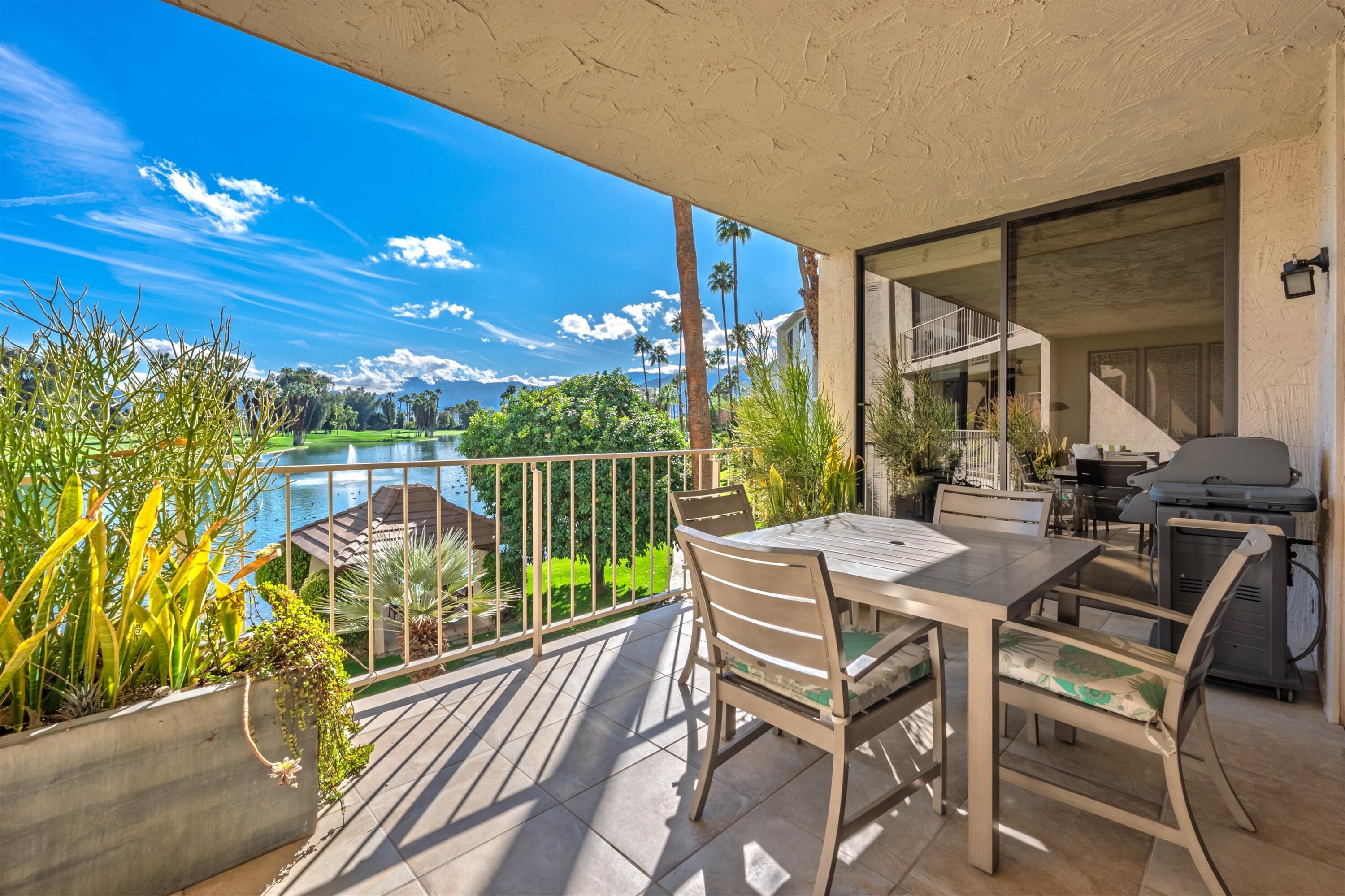 910 Island Drive, Unit 207 Rancho Mirage, CA 92270 - Photo 9 of 27 a view of a chairs and table in the balcony