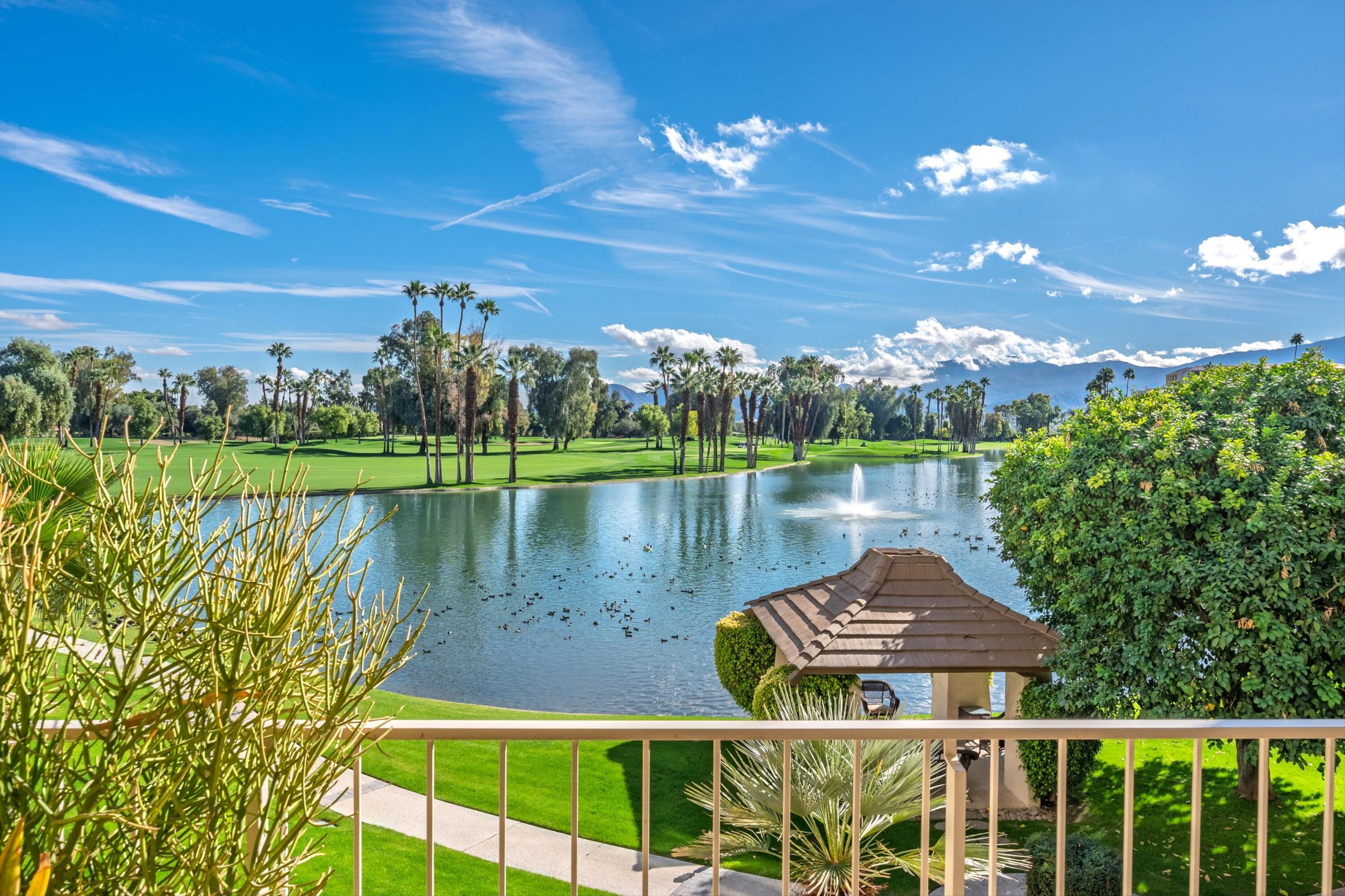 910 Island Drive, Unit 207 Rancho Mirage, CA 92270 - Photo 10 of 27 a view of a lake with a big yard