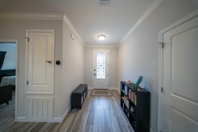 a view of hallway with wooden floor