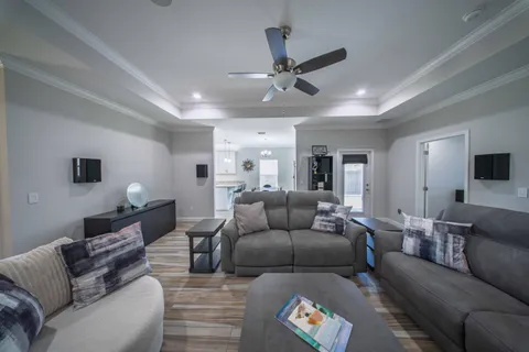 a living room with furniture and a view of kitchen