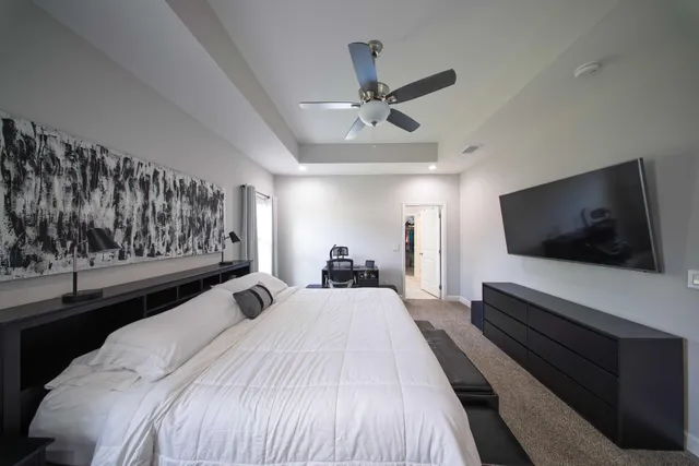 a bedroom with a large bed and a flat screen tv