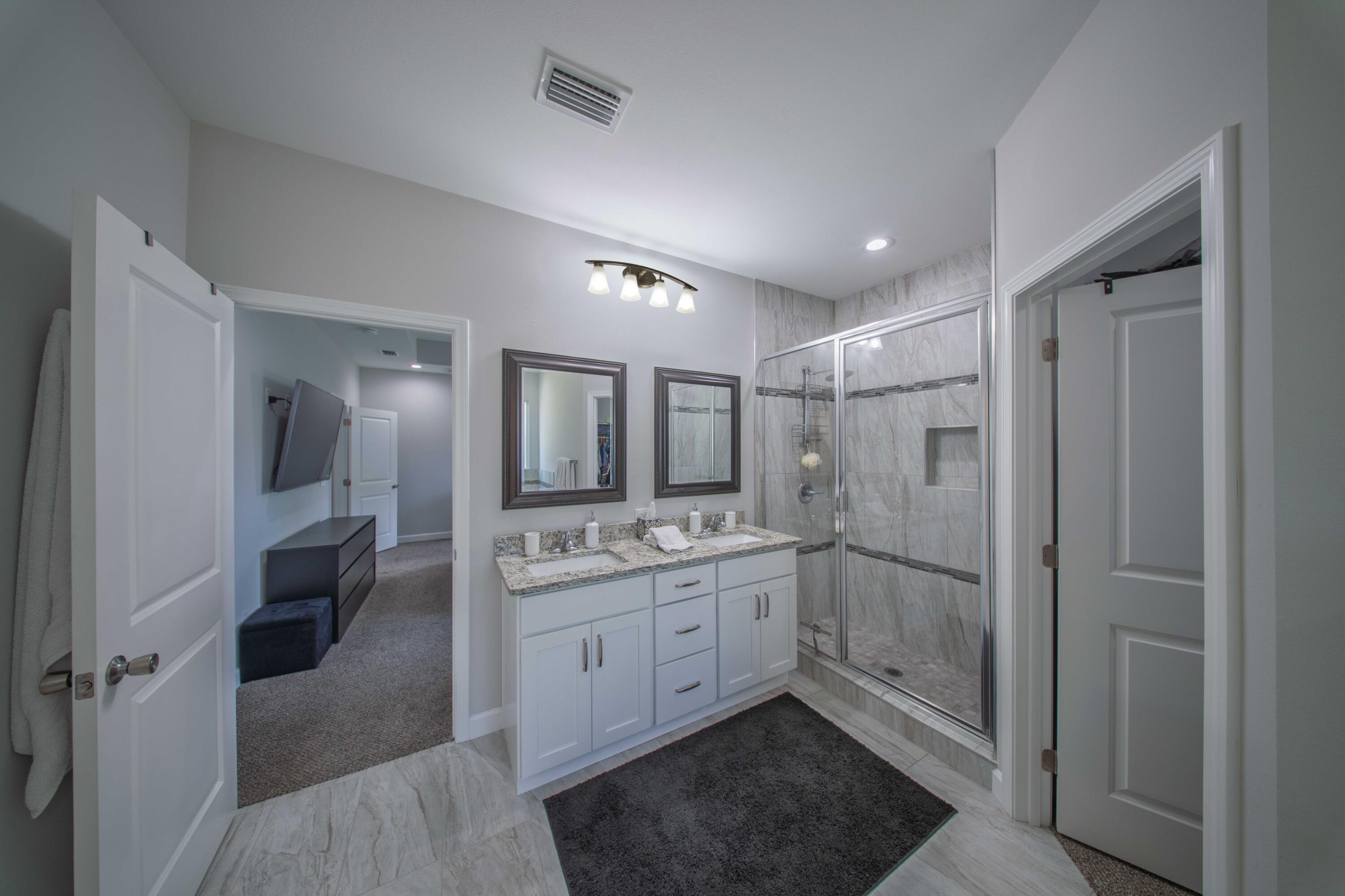 474 Sara Avenue Mary Esther, FL 32569 - Photo 26 of 46 a spacious bathroom with a shower a sink and a mirror