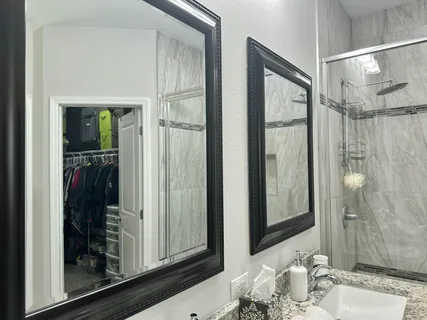 a bathroom with a mirror and a shower