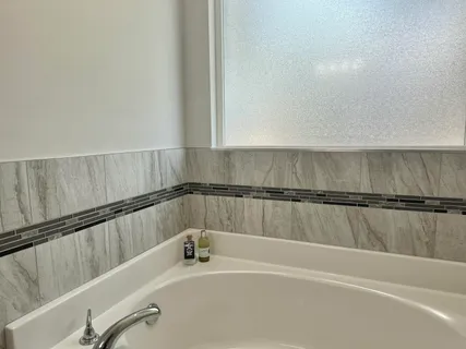 a bedroom with a bed furniture and a window