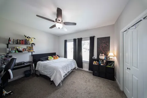 a bedroom with a bed and a chandelier