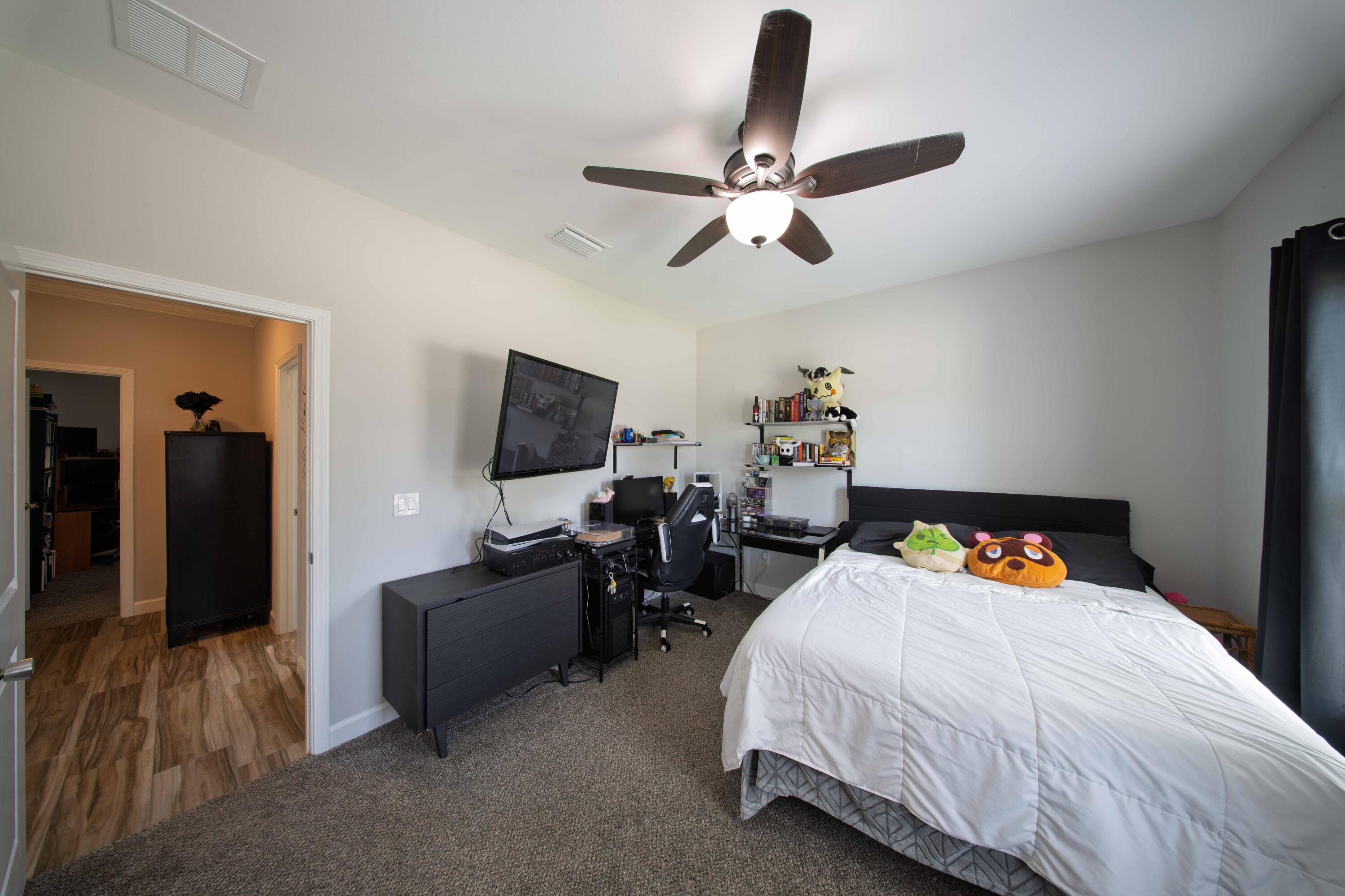 474 Sara Avenue Mary Esther, FL 32569 - Photo 32 of 46 a bedroom with a bed and a chandelier