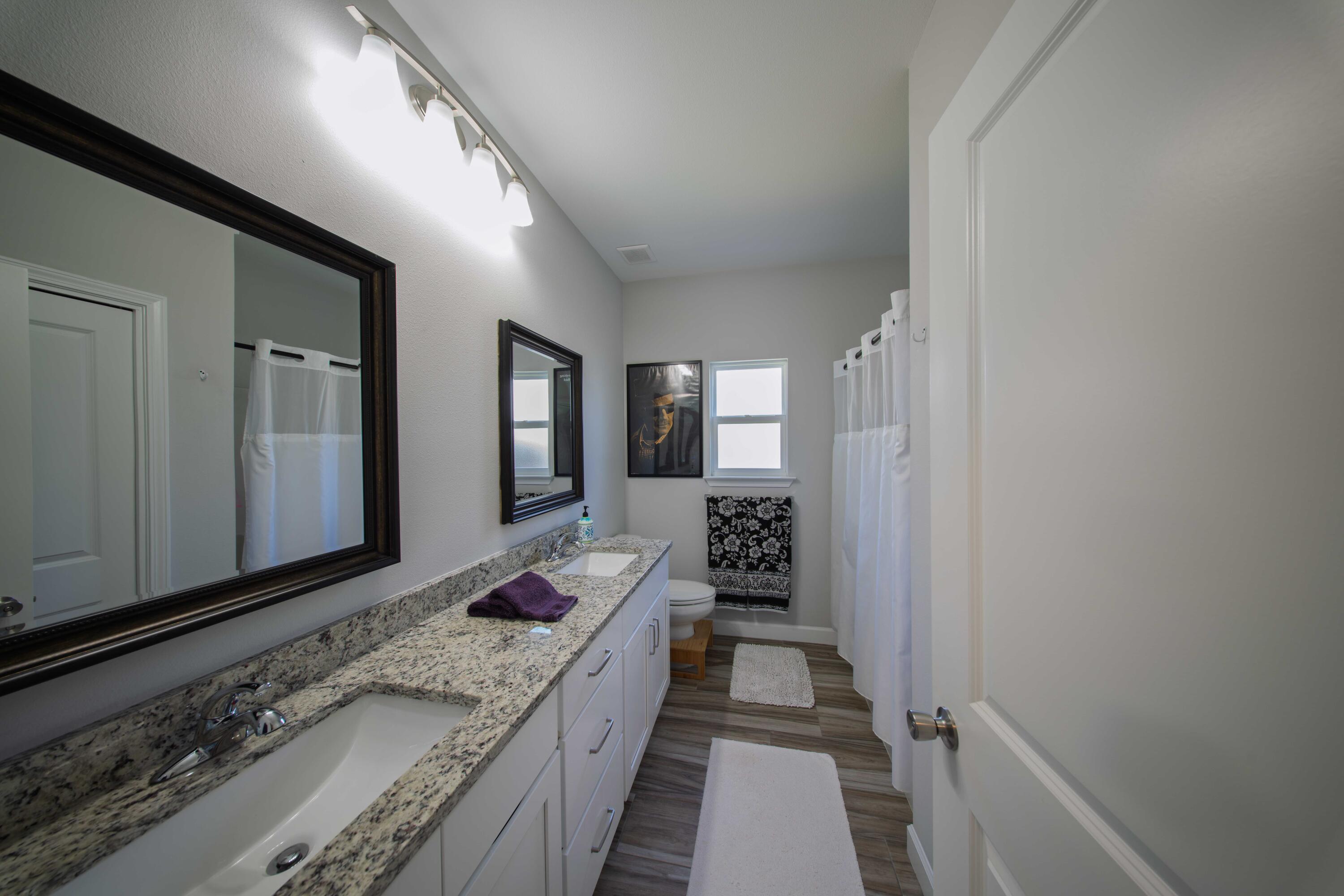 474 Sara Avenue Mary Esther, FL 32569 - Photo 33 of 46 a bathroom with a granite countertop sink and a mirror