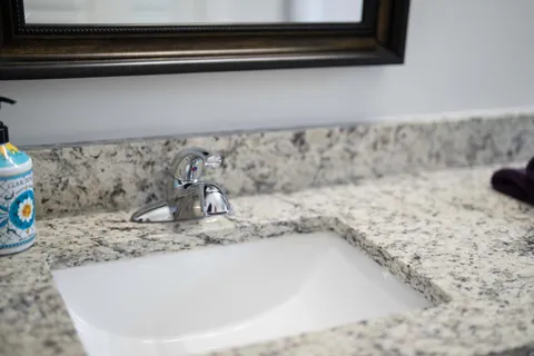 a living room with furniture and a bookshelf