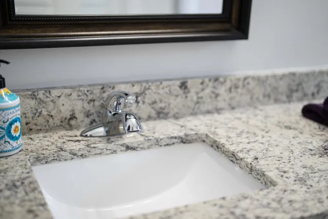 a living room with furniture and a bookshelf