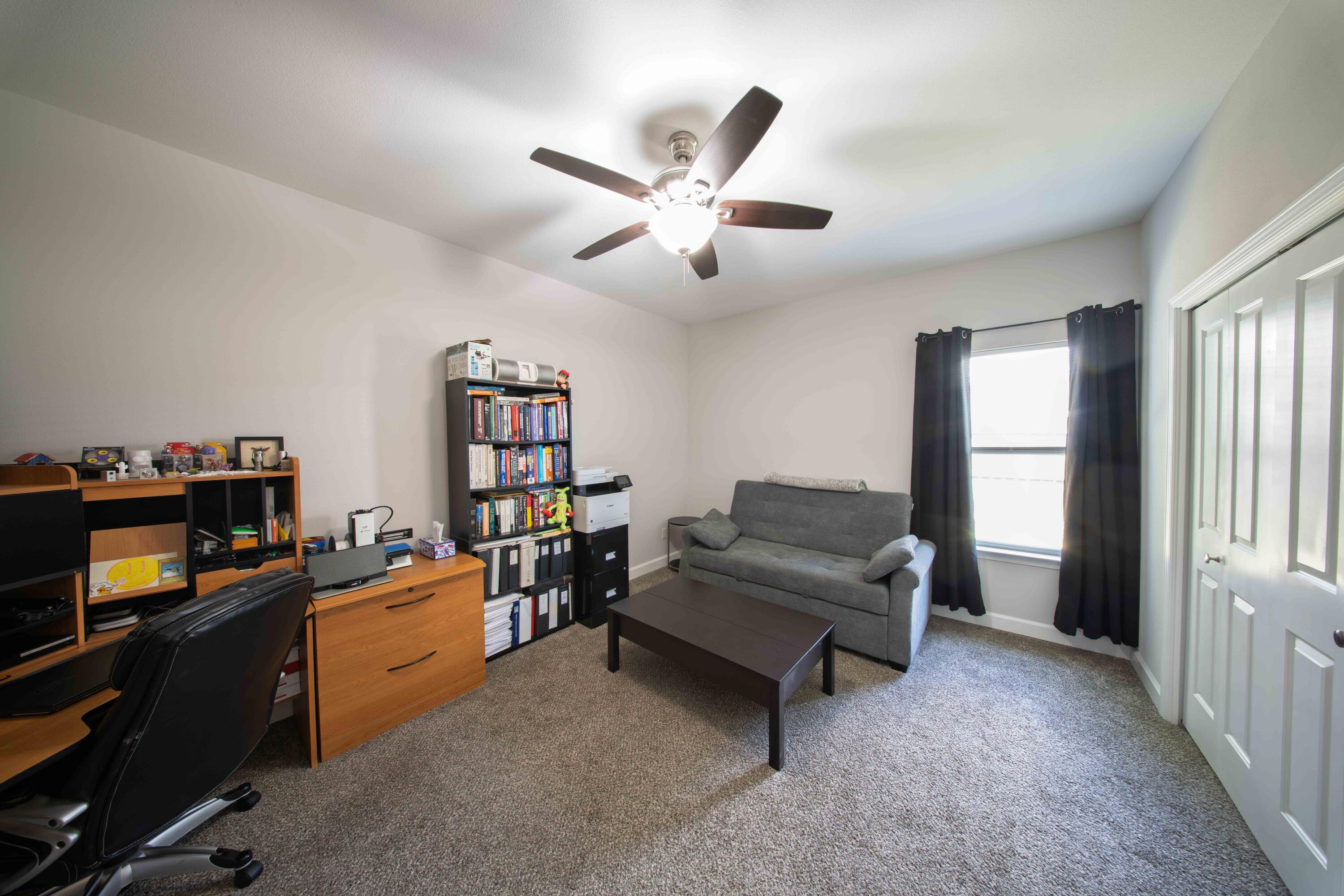 474 Sara Avenue Mary Esther, FL 32569 - Photo 35 of 46 a living room with furniture and a bookshelf