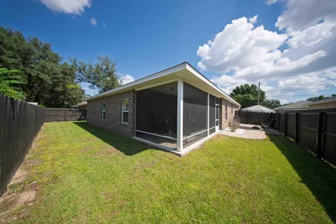 an aerial view of a house with swimming pool and furniture