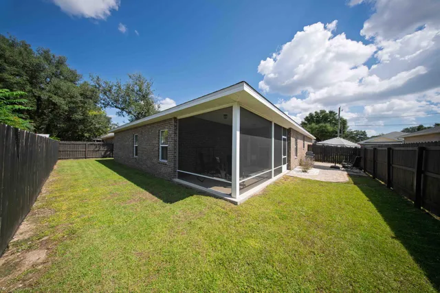 an aerial view of a house with swimming pool and furniture