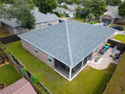 an aerial view of a house with a yard