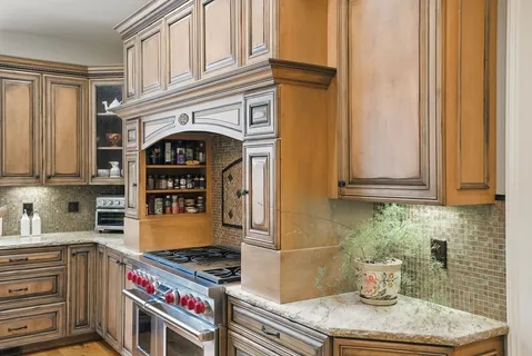 a kitchen with stainless steel appliances granite countertop a stove and a refrigerator