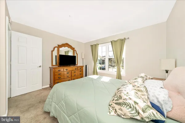 a bedroom with a bed and a flat screen tv in it
