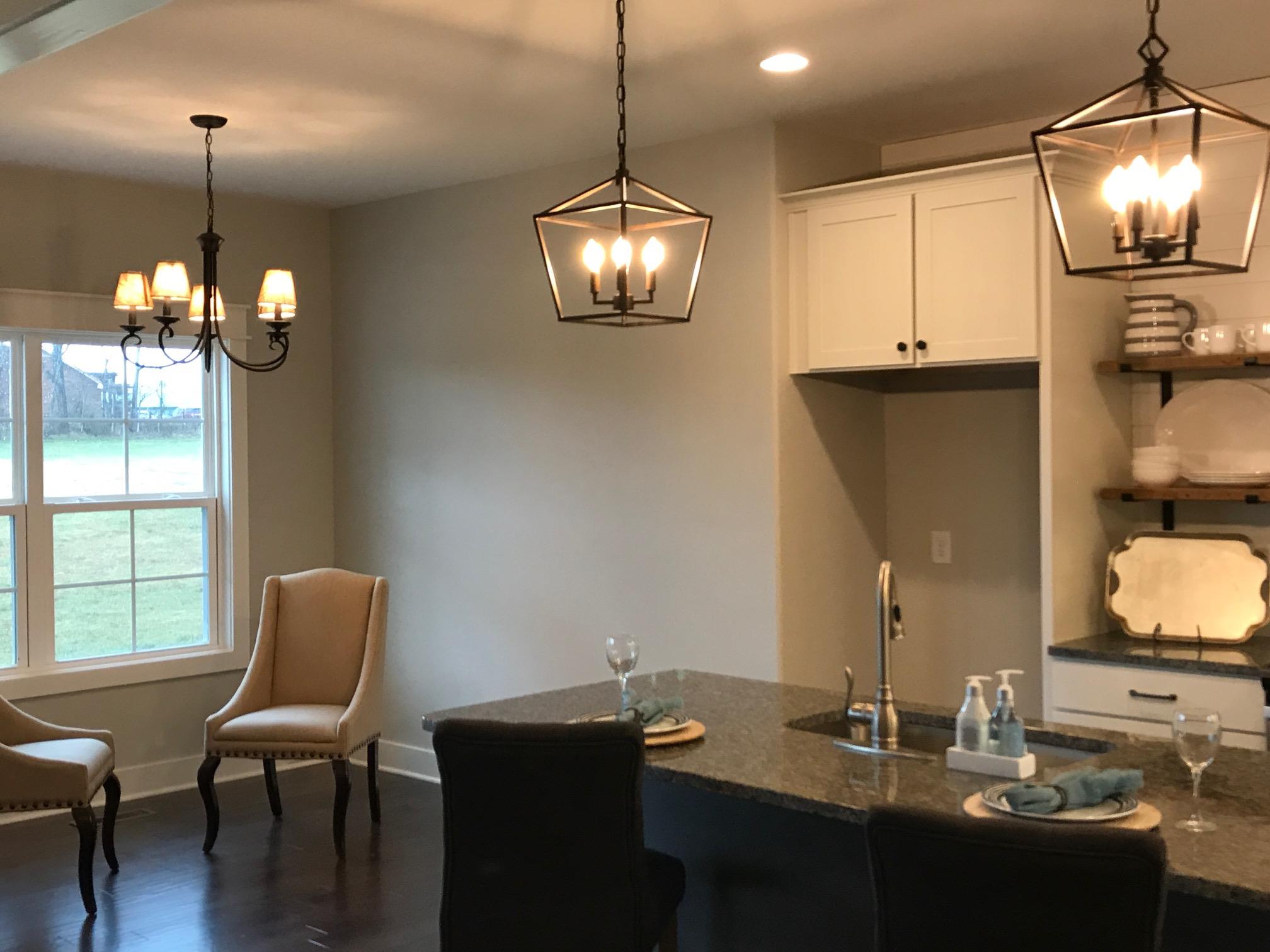 759 Philadelphia Road Lebanon, TN 37087 - Photo 8 of 21 a dining room with wooden floor a chandelier a wooden table and chairs