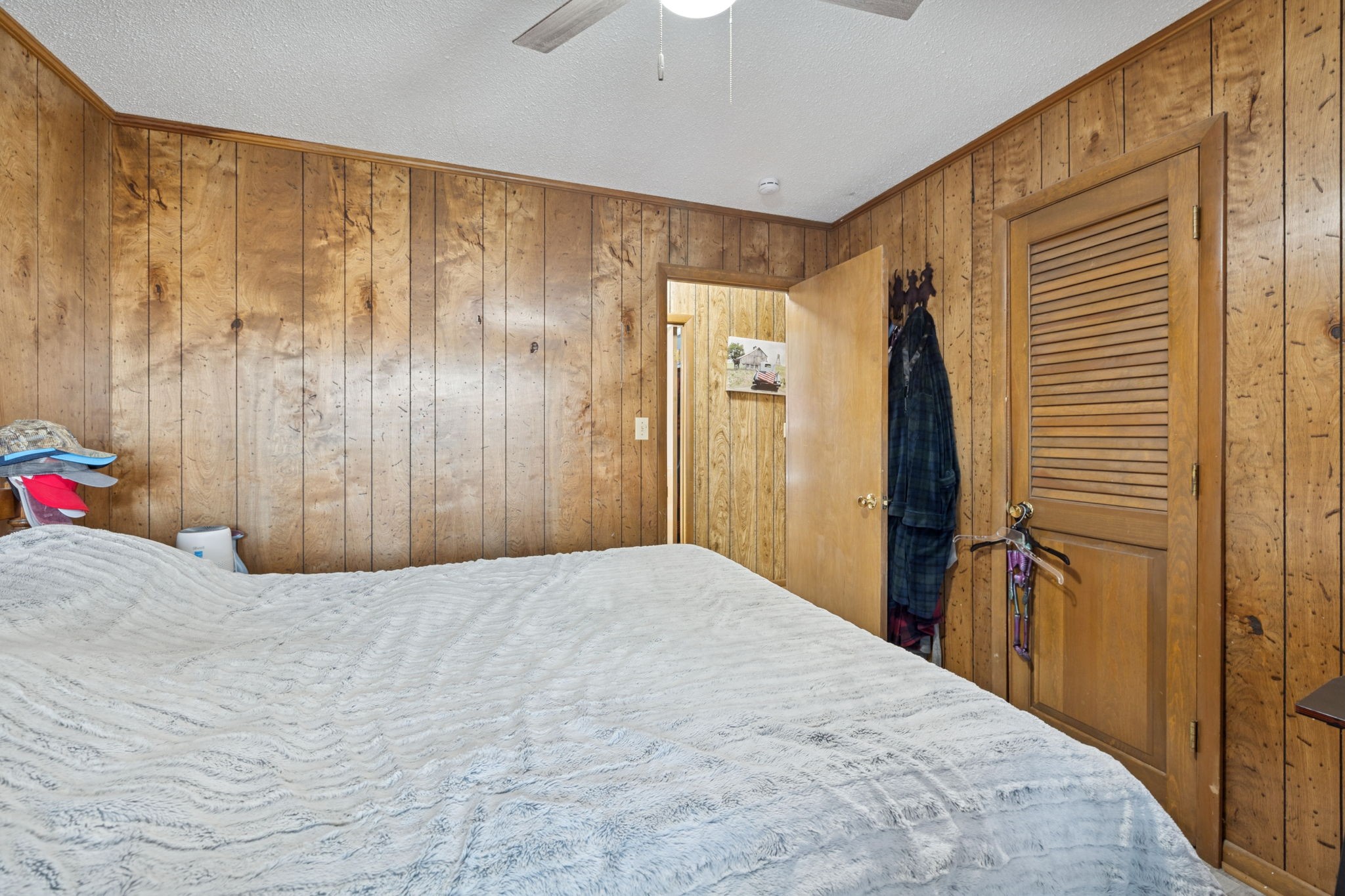 535 Gamaliel Road Red Boiling Springs, TN 37150 - Photo 17 of 30 a bedroom with a bed and a chandelier fan
