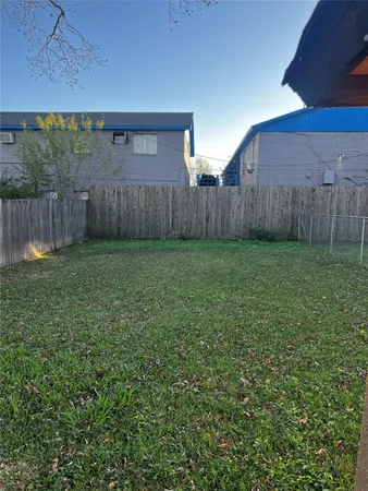 a view of a backyard with wooden fence