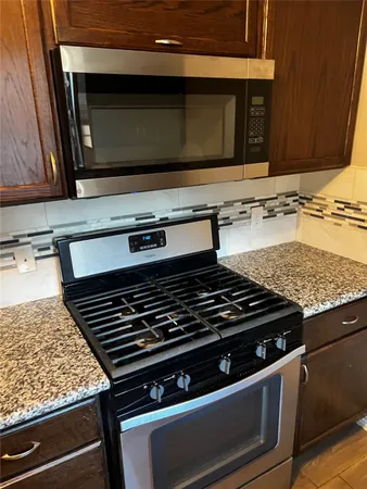 a stove top oven sitting inside of a kitchen