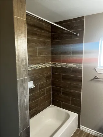 a bathroom with a shower and a sink