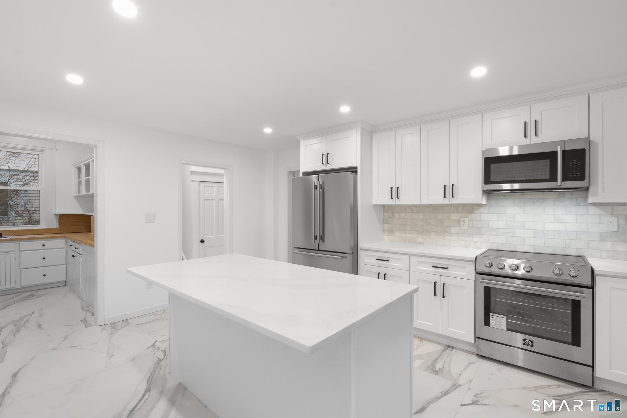 74 Cold Spring Street New Haven, CT 06511 - Photo 11 of 40 a kitchen with a stove a sink and a refrigerator