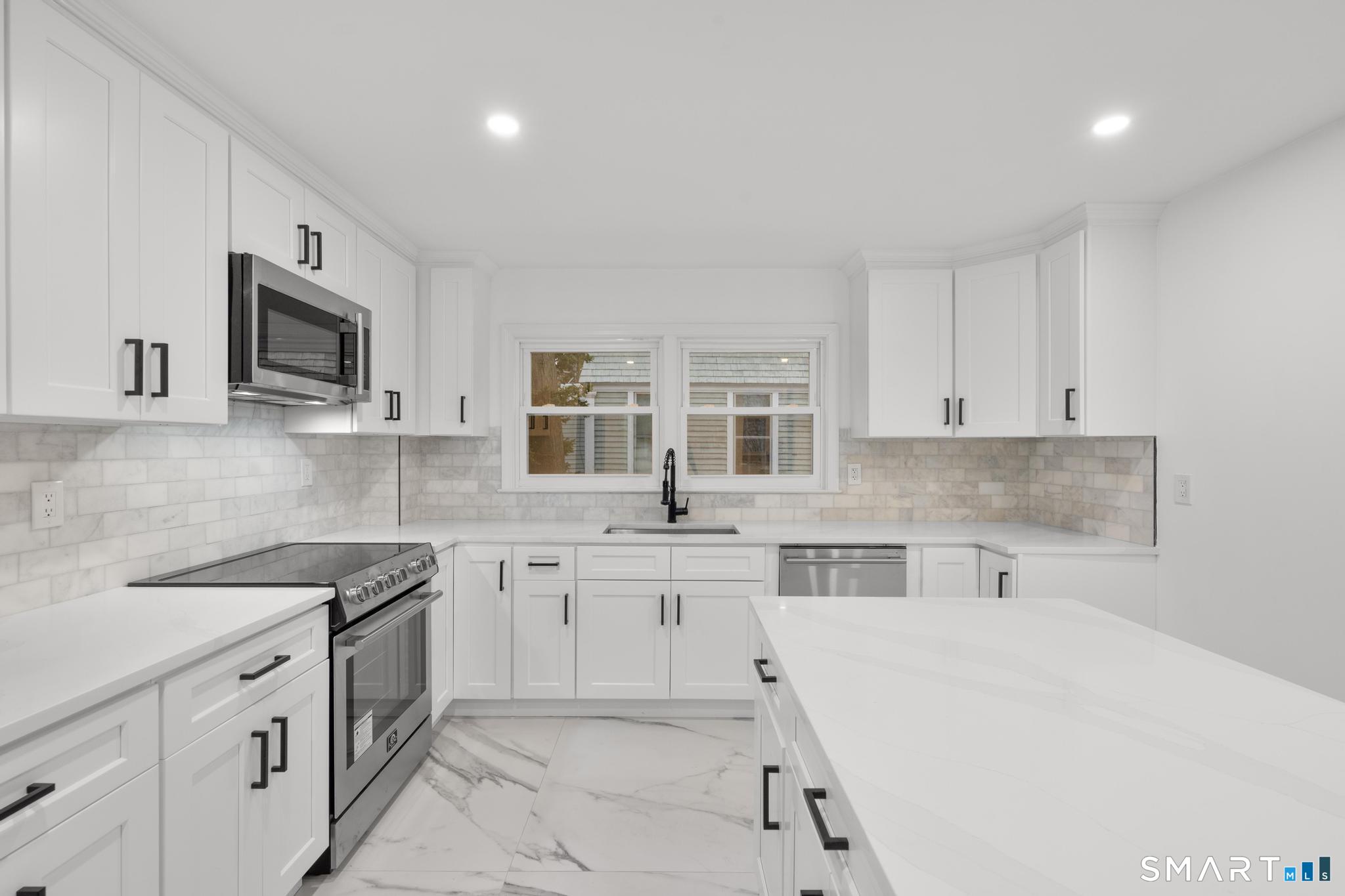 74 Cold Spring Street New Haven, CT 06511 - Photo 12 of 40 a open kitchen with stainless steel appliances granite countertop a sink and dishwasher a stove top oven with white cabinets