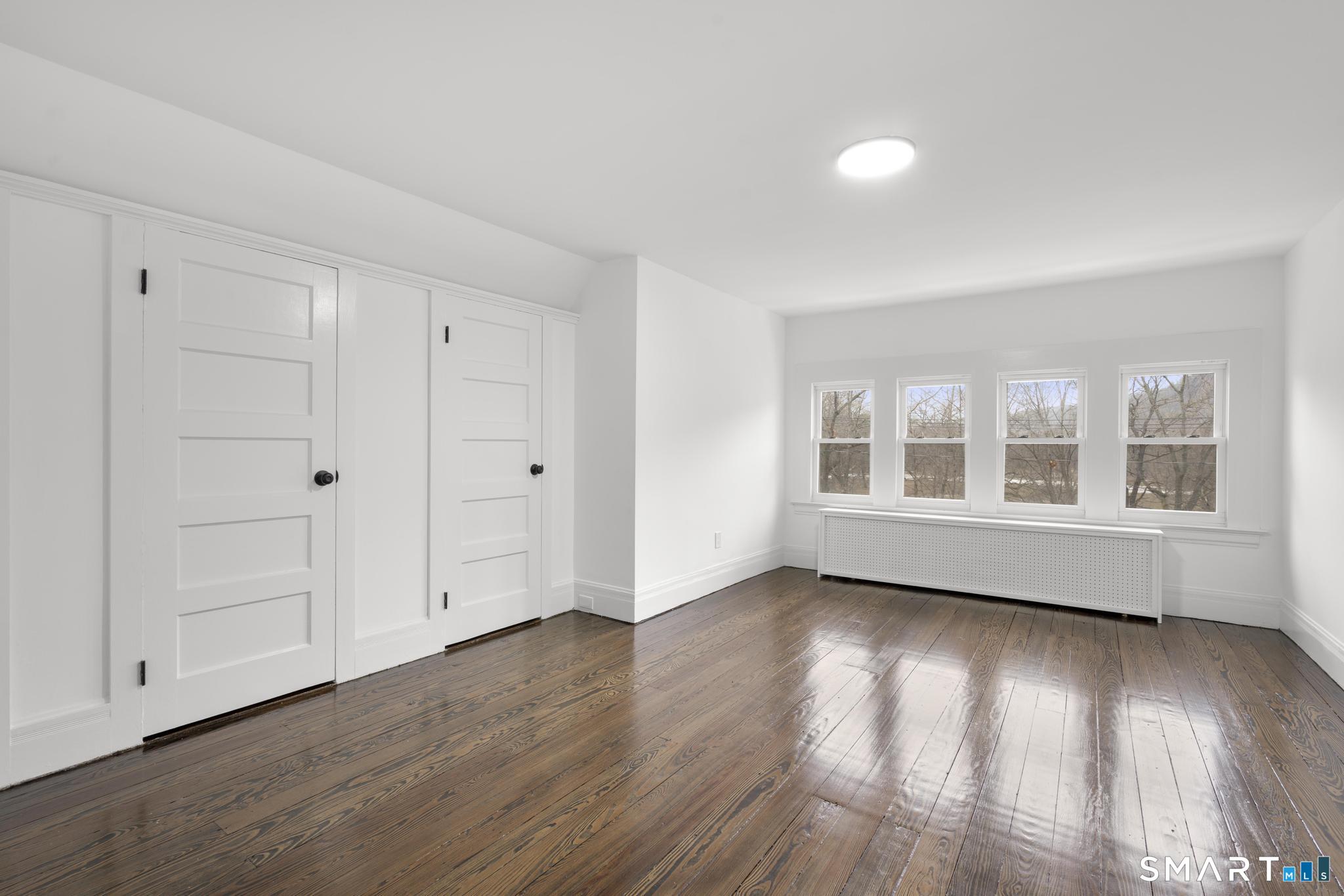 74 Cold Spring Street New Haven, CT 06511 - Photo 15 of 40 a view of an empty room with wooden floor and a window