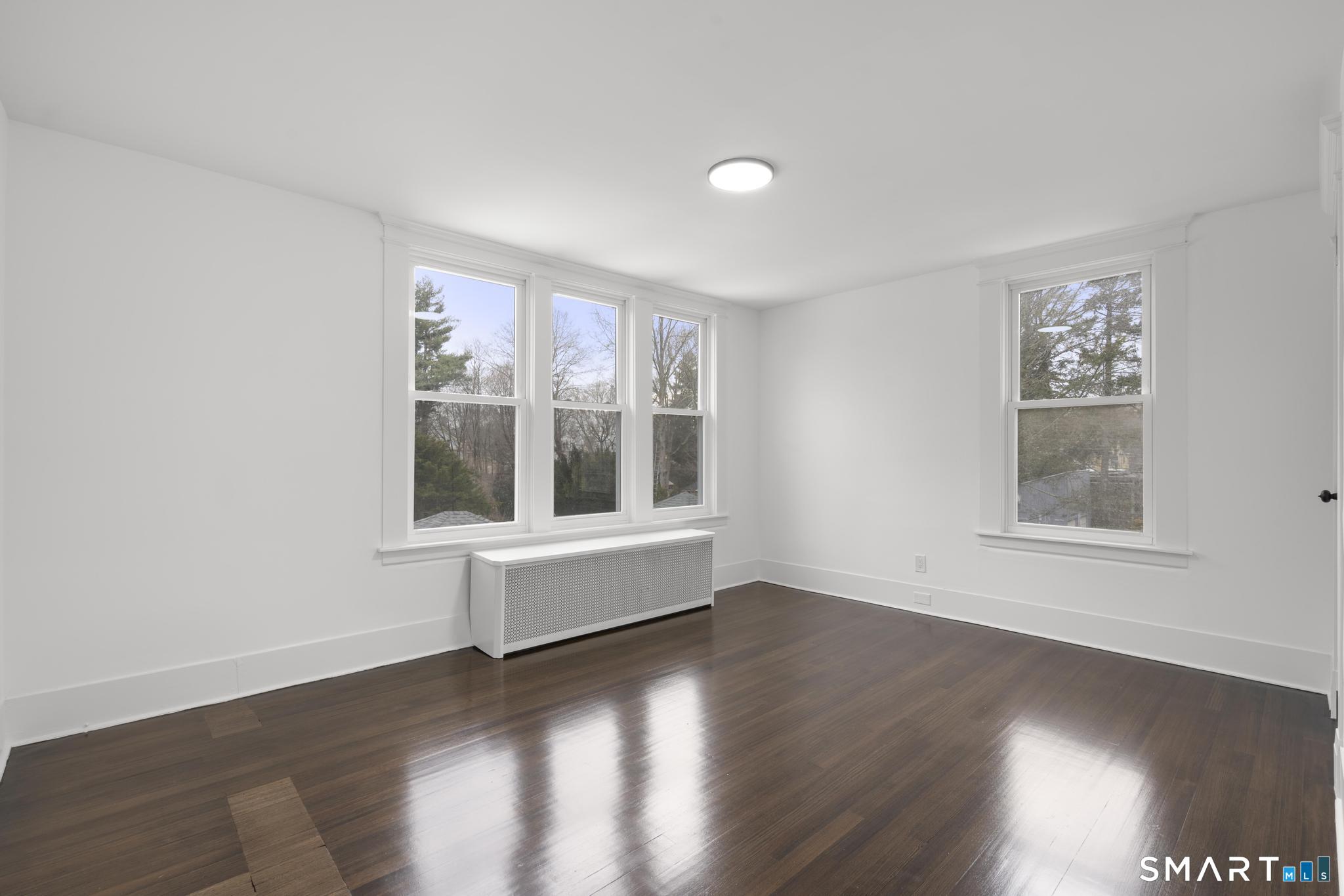 74 Cold Spring Street New Haven, CT 06511 - Photo 17 of 40 a view of an empty room with wooden floor and a window